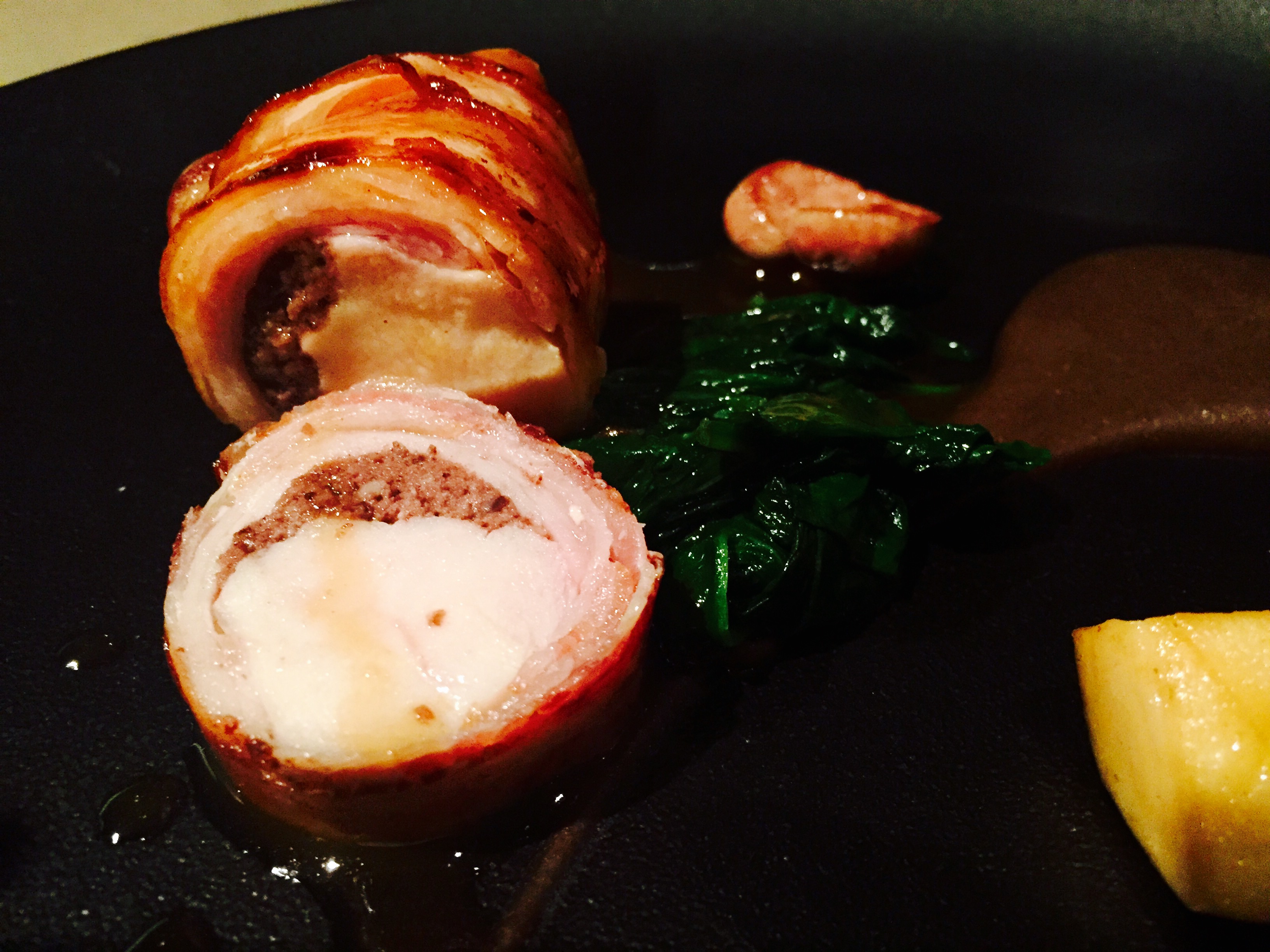 Rabbit roulade with black pudding textures, spinach, king oyster, rabbit kidney and chicken jus