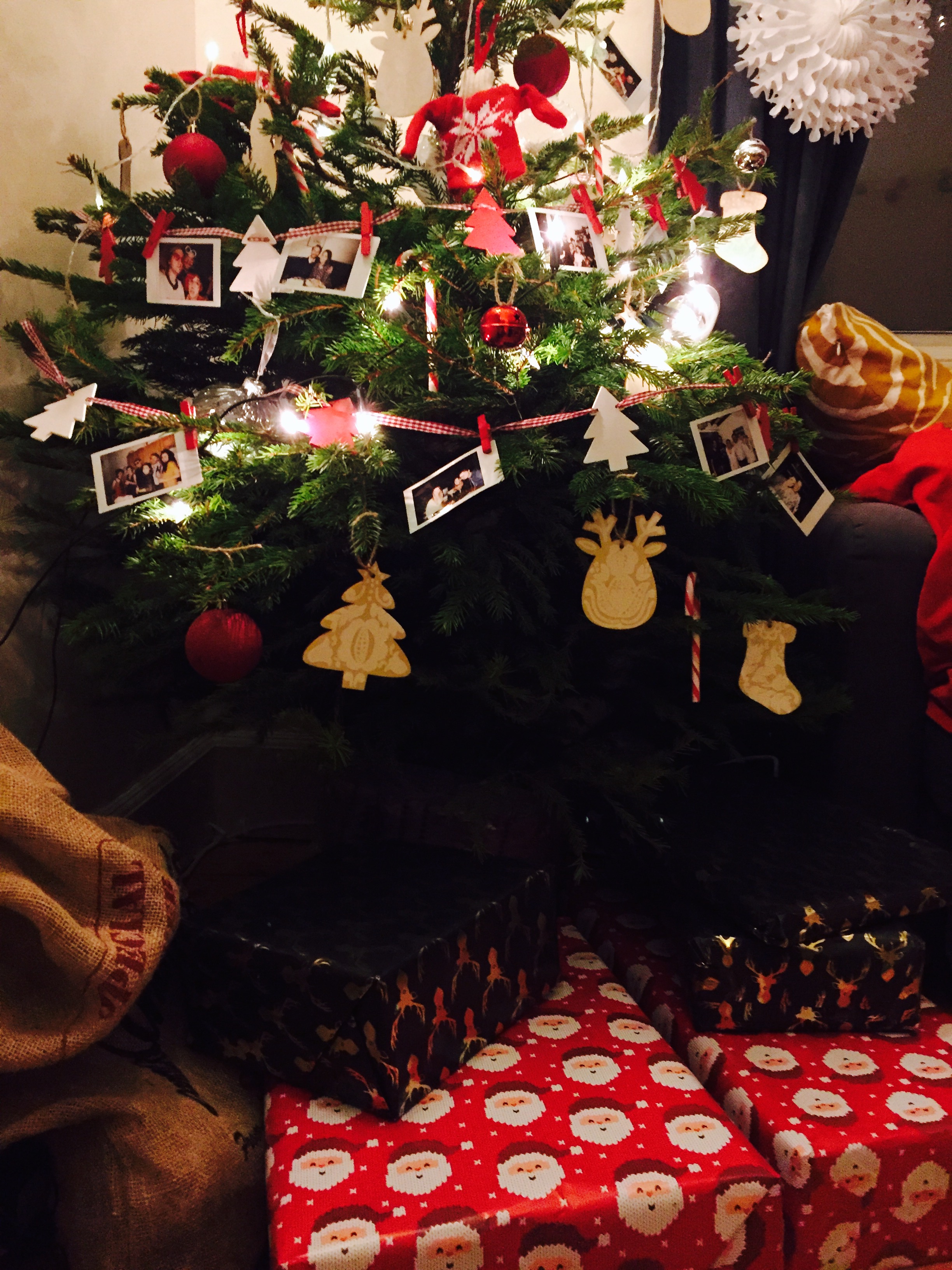A Christmas tree full of polaroid pictures and handpainted decorations
